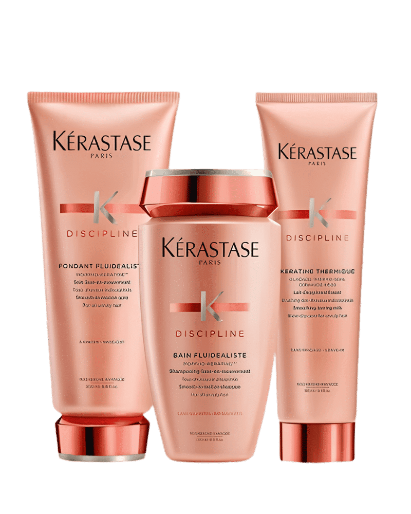 Kérastase Discipline hair care products in peach-colored packaging.