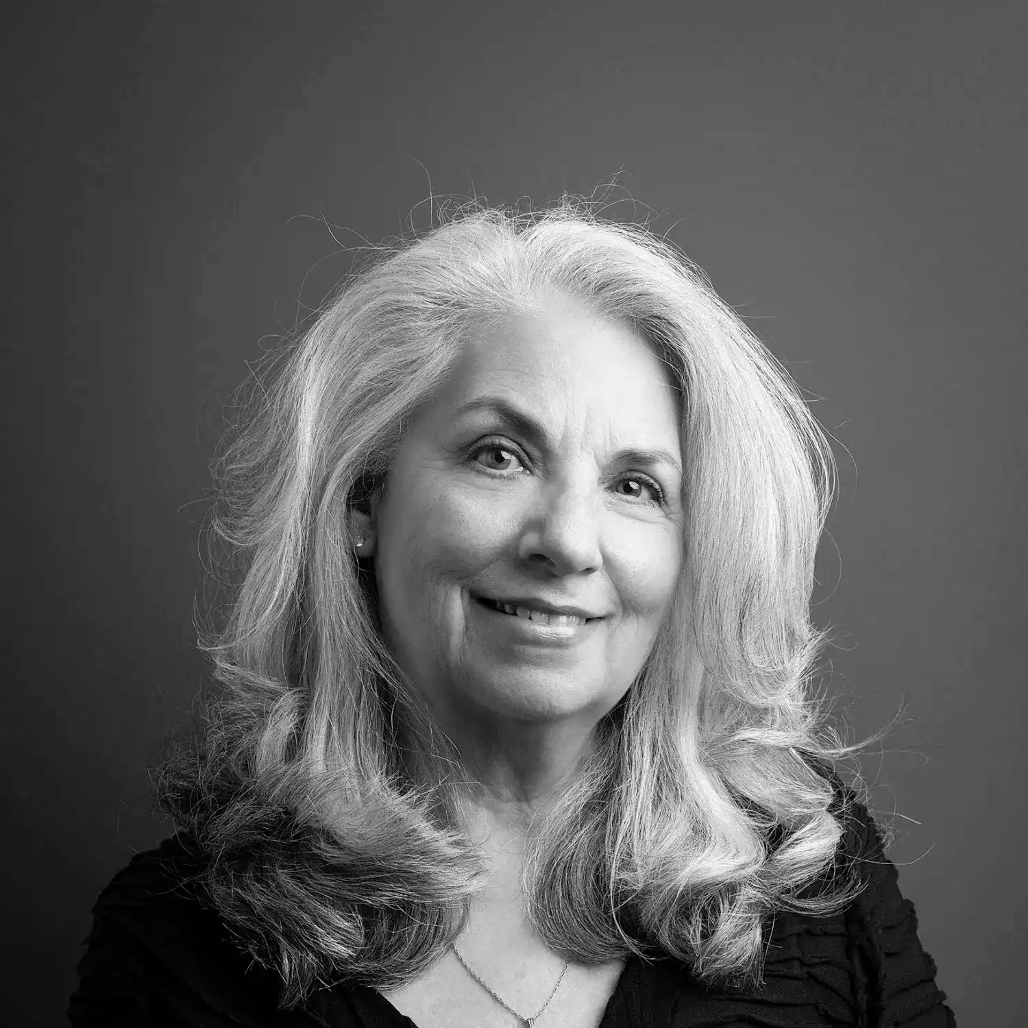 Portrait of Arlene Sulkis, a professional stylist at Salon SCK, showcasing their expertise and style.