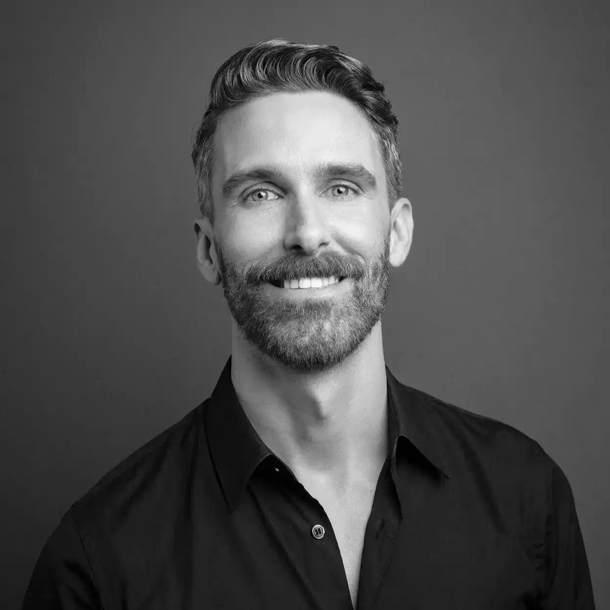 Portrait of Danny Garrity, a professional stylist at Salon SCK, showcasing their expertise and style.