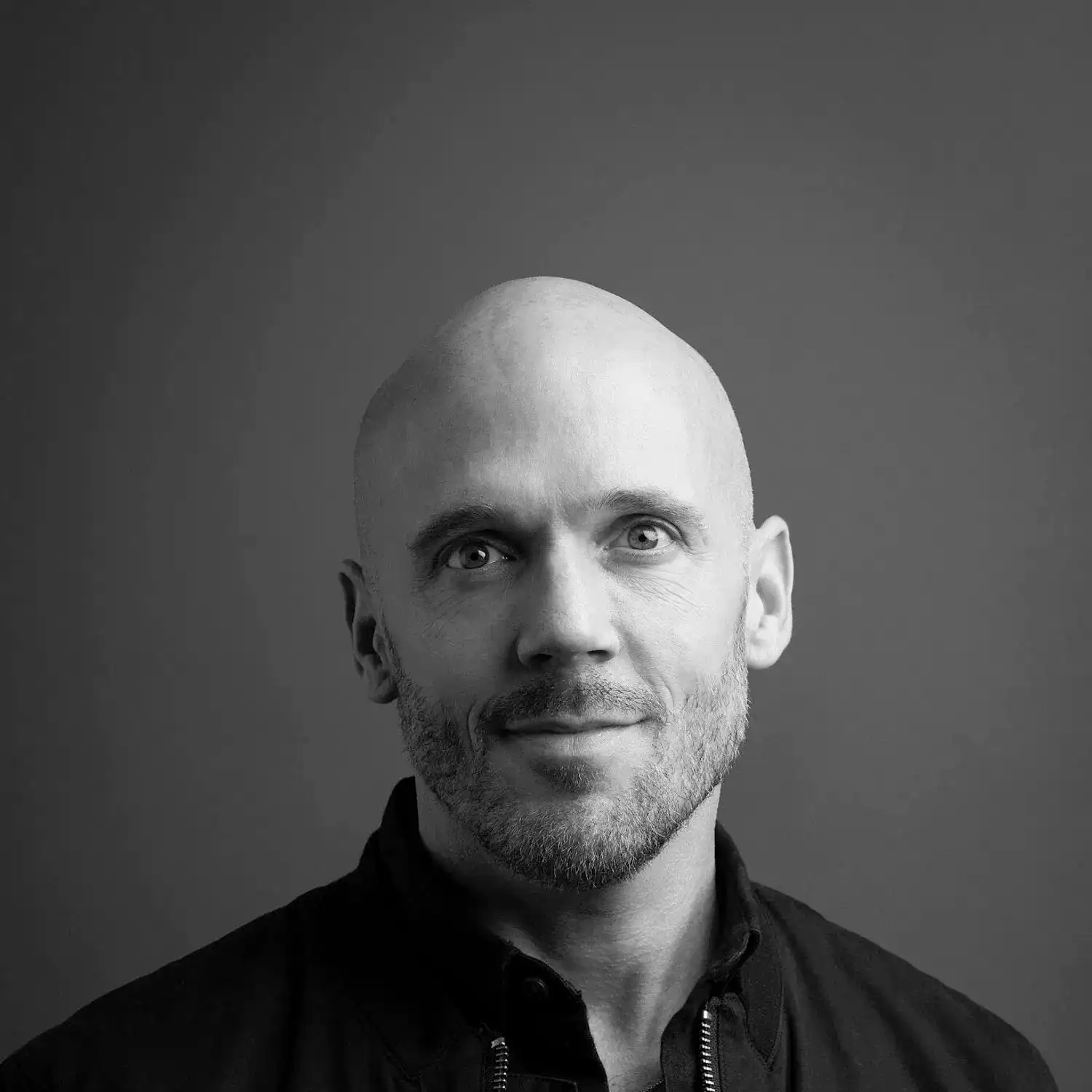 Portrait of Dallas Benjamin, a professional stylist at Salon SCK, showcasing their expertise and style.