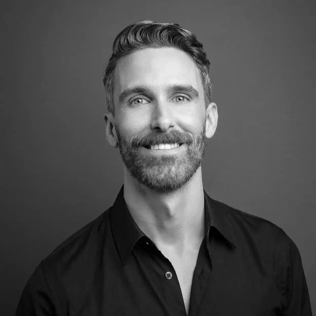 Portrait of Danny Garrity, a professional stylist at Salon SCK, showcasing their expertise and style.