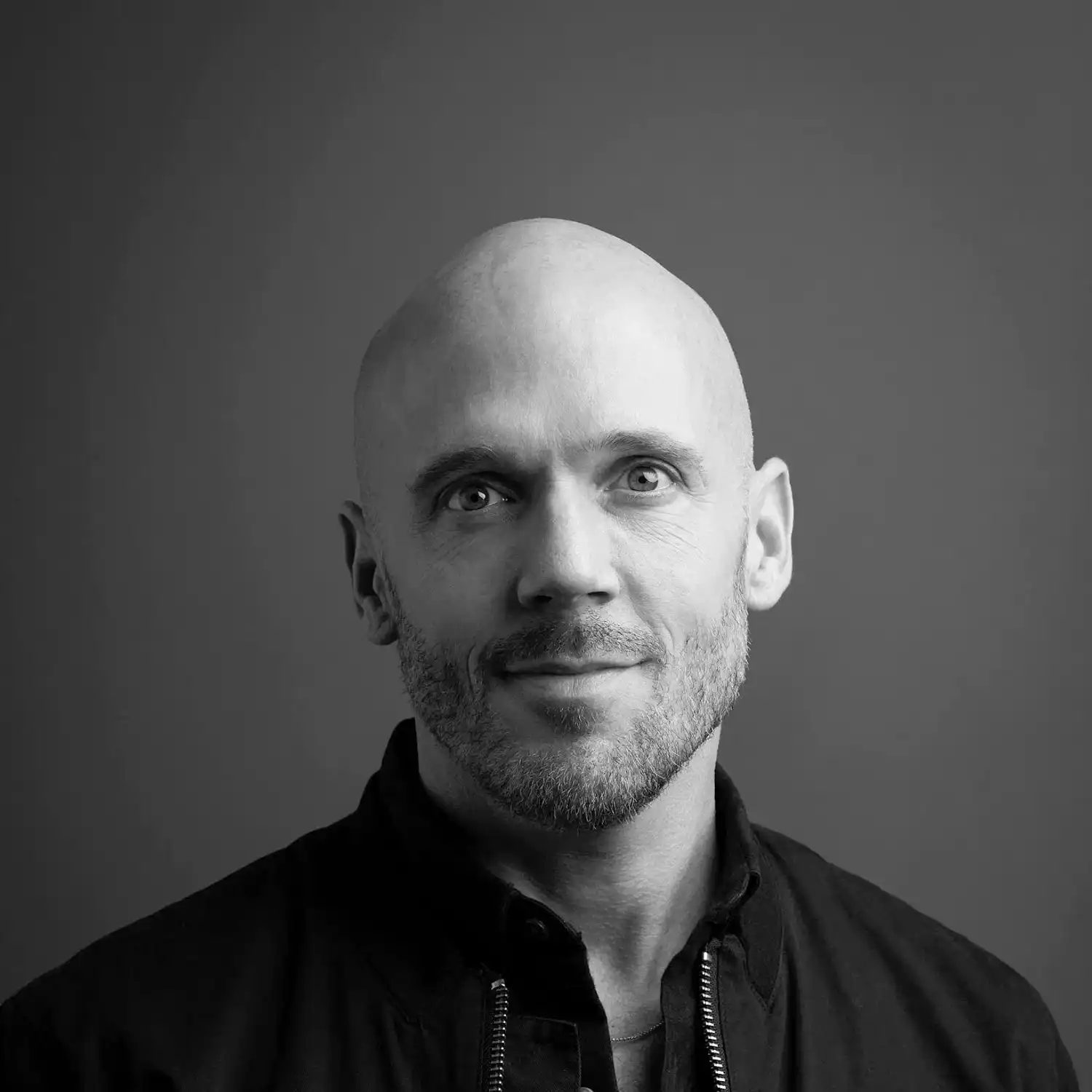 Portrait of Dallas Benjamin, a professional stylist at Salon SCK, showcasing their expertise and style.