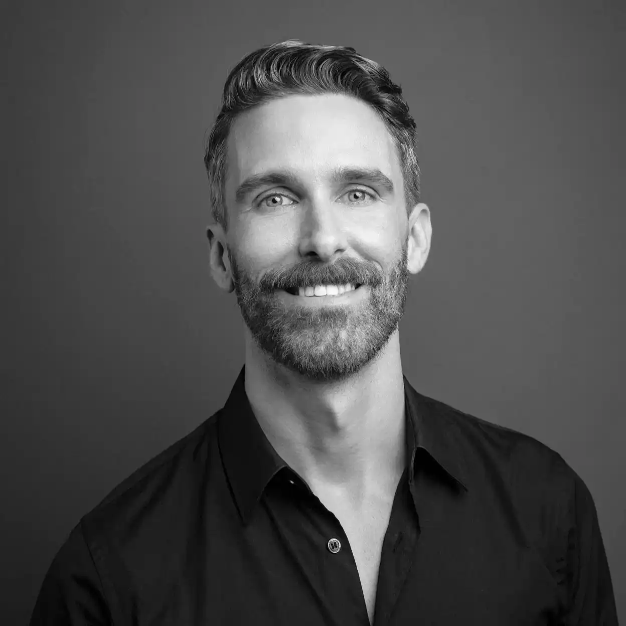 Portrait of Danny Garrity, a professional stylist at Salon SCK, showcasing their expertise and style.