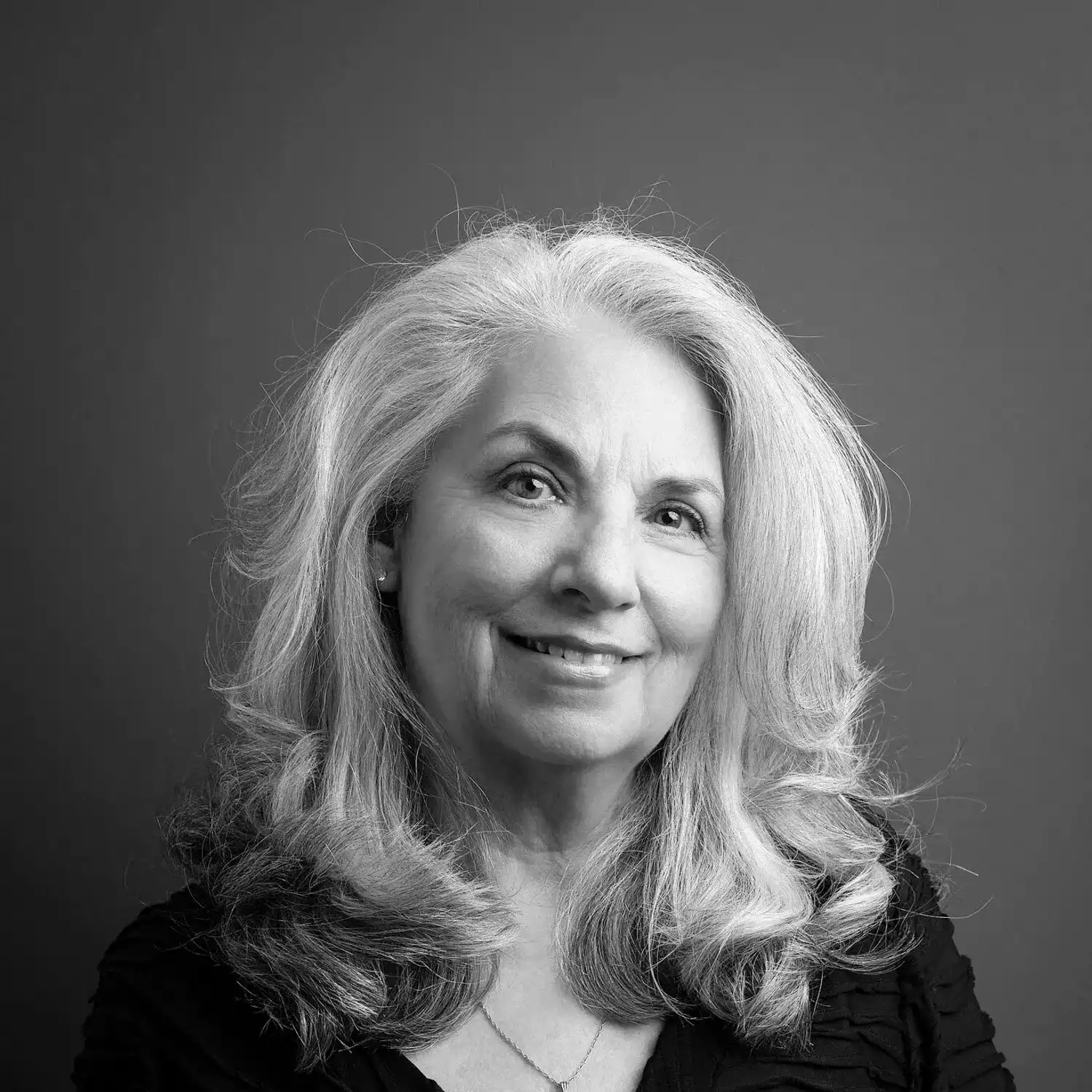 Portrait of Arlene Sulkis, a professional stylist at Salon SCK, showcasing their expertise and style.