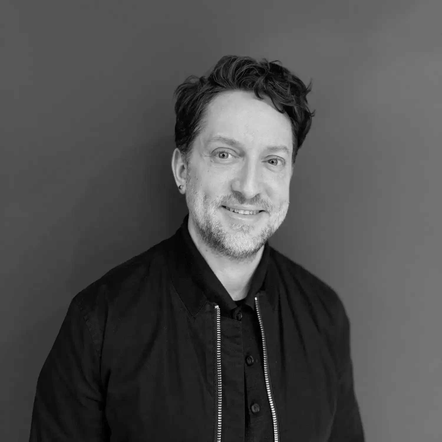 Portrait of Clint Wilson, a professional stylist at Salon SCK, showcasing their expertise and style.