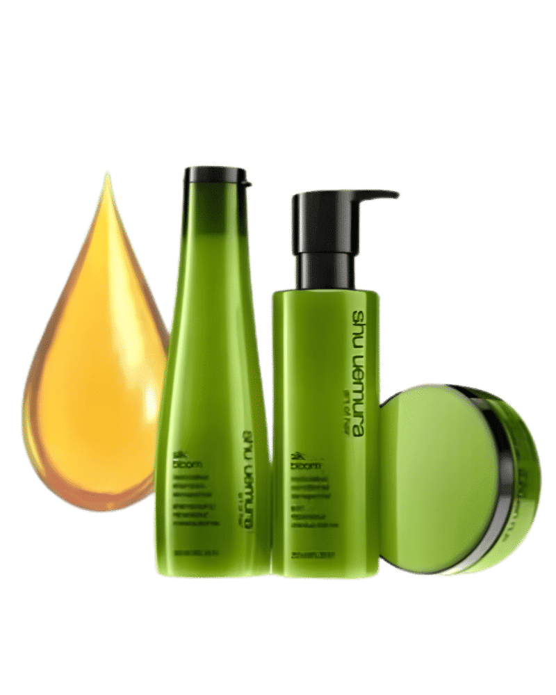 Hair care products with green bottles and a drop of yellow oil.