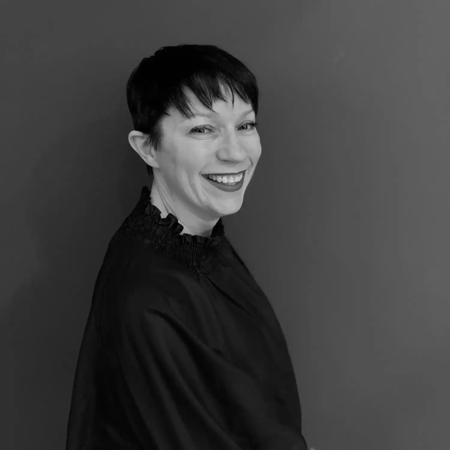 Portrait of Carmel Lawless, a professional stylist at Salon SCK, showcasing their expertise and style.